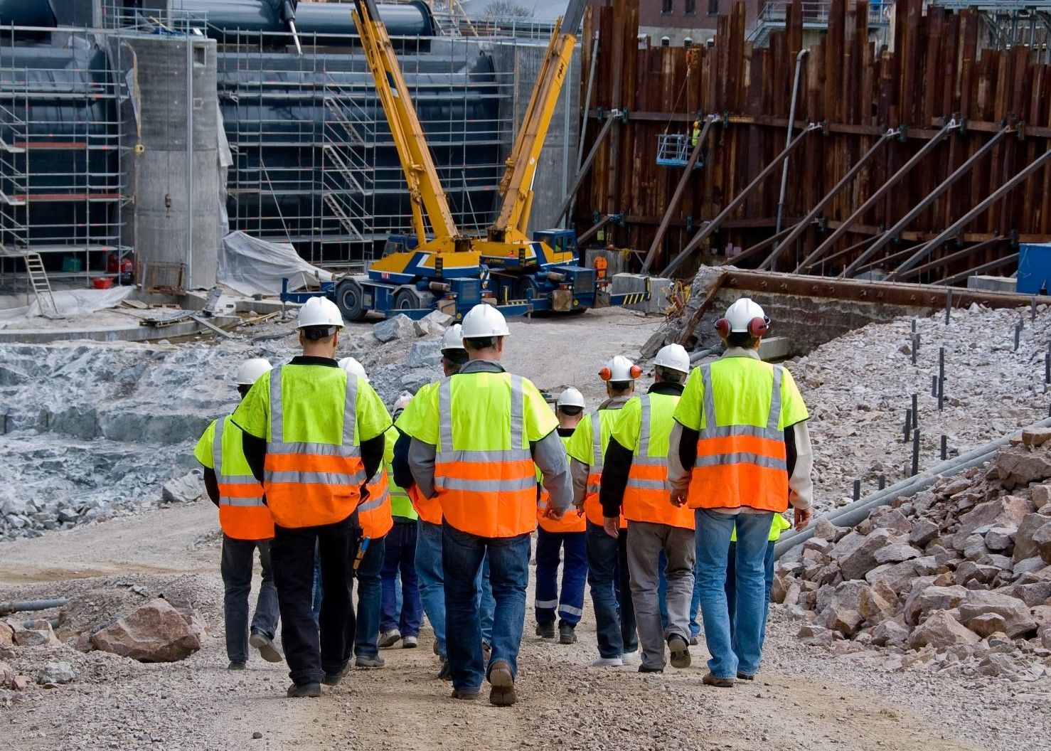construction workers walking into construction site