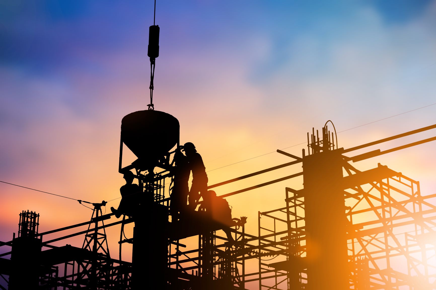 workers standing on construction scaffolding